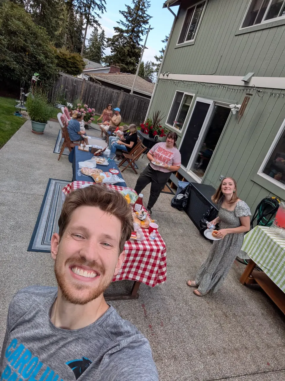 Friends saying hi at a backyard dinner
